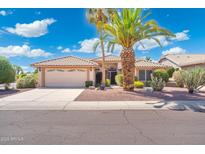 Charming single-story home featuring a well-manicured front yard with desert landscaping and a two-car garage at 8958 W Rosemonte Dr, Peoria, AZ 85382