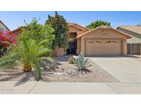 Inviting single-story home featuring a well-manicured desert front yard and two-car garage at 10367 E Wood Dr, Scottsdale, AZ 85260
