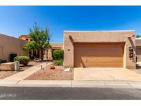 Charming single-story home featuring desert landscaping and a two-car garage in a peaceful residential neighborhood at 14428 W Moccasin Trl, Surprise, AZ 85374