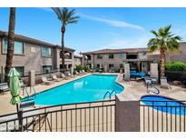 Resort-style pool area with lounge chairs, hot tub, pergola, and beautiful landscaping for relaxation at 14815 N Fountain Hills Blvd # 201, Fountain Hills, AZ 85268