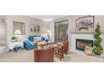 Cozy living room with a comfortable blue sofa, fireplace, and sliding glass door at 15252 N 100Th St # 1164, Scottsdale, AZ 85260