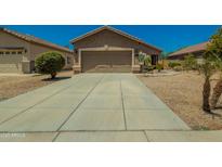 Beautiful single-story home with desert landscaping and a spacious driveway offers great curb appeal at 15354 W Caribbean Ln, Surprise, AZ 85379