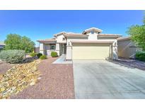 Charming single-story home featuring a two-car garage and a well-maintained, low maintenance front yard at 16389 N 180Th Dr, Surprise, AZ 85388