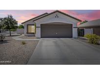 Charming single-story home featuring a two-car garage and low-maintenance desert landscaping at 16523 W Desert Bloom St, Goodyear, AZ 85338