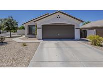Single Gathering house with a two car garage and low maintenance landscaping at 16523 W Desert Bloom St, Goodyear, AZ 85338