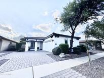 Charming single-story home with a well-manicured front yard and paved driveway at 1812 S Racine Ln, Gilbert, AZ 85295