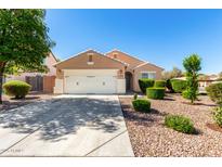Charming single-story home featuring a well-manicured front yard and a two-car garage at 2053 E Saddlebrook Ct, Gilbert, AZ 85298