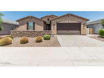 Charming single-story home features a stone accent wall, desert landscaping, and a two-car garage at 3948 E Caitlin Dr, San Tan Valley, AZ 85140