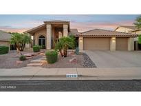 Inviting home featuring a three car garage, desert landscaping, and a covered entry at 4146 N Lomond --, Mesa, AZ 85215