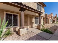 Charming two-story home with a stucco facade, decorative columns, and well-maintained landscaping at 4601 N 102Nd Ave # 1178, Phoenix, AZ 85037