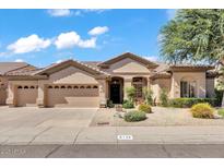 Charming single-story home featuring a three-car garage, desert landscaping, and a welcoming entrance at 6135 E Campo Bello Dr, Scottsdale, AZ 85254