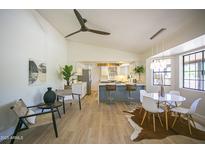 Bright, open dining area features a modern table set and flows into the kitchen with bar seating at 6608 E Ranch Rd, Cave Creek, AZ 85331