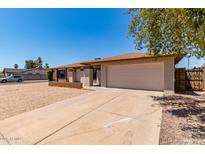 Charming single-story home with a well-maintained yard and a spacious two-car garage at 662 W Laguna Azul Ave, Mesa, AZ 85210