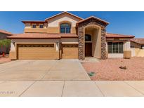 Stunning two-story home featuring a stone-accented entrance, three-car garage, and a well-maintained front yard at 7418 S 25Th Ln, Phoenix, AZ 85041