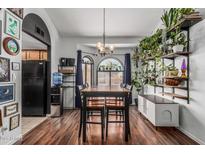 Bright dining room with wood floors, black accents, and lots of natural light from the large arched windows at 850 S River Dr # 2065, Tempe, AZ 85281