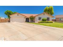 Charming single-story home featuring a spacious driveway and a well-maintained lawn at 930 N Sandal Cir, Mesa, AZ 85205
