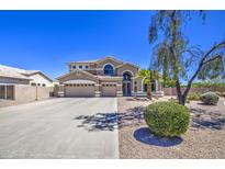 A two-story house with an attached three-car garage and an expansive driveway on a sunny day at 9347 E Hillview Cir, Mesa, AZ 85207