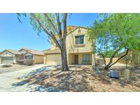 Charming two-story home featuring a well-manicured front yard and a two-car garage at 10524 W Pima St, Tolleson, AZ 85353