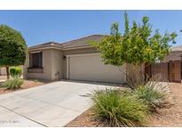 Charming single-story home featuring a two-car garage and desert landscaping at 12109 W Tether Trl, Peoria, AZ 85383