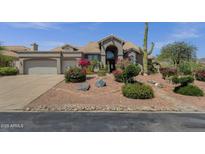 Beautiful exterior elevation with a desert landscape, barrel tile roof, and spacious driveway at 12638 E Cortez Dr, Scottsdale, AZ 85259