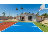 A spacious backyard featuring a colorful sport court, perfect for recreation and outdoor enjoyment at 13805 N 31St Ave, Phoenix, AZ 85053