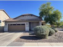 Charming single-story home featuring a well-maintained front yard and a two-car garage at 178 W Pacific Dr, Casa Grande, AZ 85122