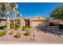 Inviting single-story home featuring a well-manicured front yard with desert landscaping and a charming covered entryway at 2680 E Daniel Dr, Gilbert, AZ 85298