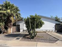 Charming single-story home featuring xeriscaping, a mature palm, and attractive desert landscaping at 2731 E Bramble Ave, Mesa, AZ 85204