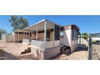 Cozy home featuring a screened porch, small yard, and classic mobile home design, awaiting personal touches at 3541 W Monona Dr, Glendale, AZ 85308