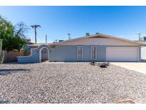 Charming single-story home with a well-maintained front yard and a convenient attached two-car garage at 3811 W Loma Ln, Phoenix, AZ 85051