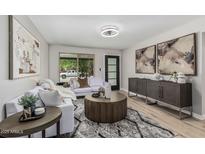 Bright living room with stylish furnishings, modern decor, and a large window at 4416 E Capistrano Ave, Phoenix, AZ 85044