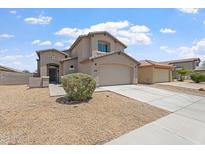 Charming two-story home featuring desert landscaping and a two-car garage on a sunny day at 5420 W Grove St, Laveen, AZ 85339