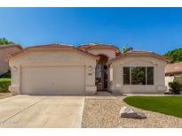 Charming single-story home featuring stucco siding, a two-car garage, and manicured desert landscaping at 6502 W Wahalla Ln, Glendale, AZ 85308
