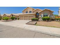 Inviting two-story home featuring a three-car garage and well-maintained front yard landscaping at 728 W Sandra Ter, Phoenix, AZ 85023