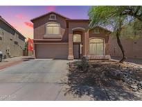 Inviting two-story home featuring desert landscaping and a convenient two-car garage at 7725 S 47Th Ln, Laveen, AZ 85339