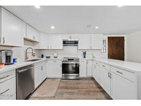 Updated kitchen with white cabinets, stainless appliances, and wood-look floors is move-in ready at 7920 E Camelback Rd # 508, Scottsdale, AZ 85251