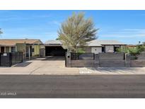 Charming single-story home featuring a well-maintained front yard and a driveway with covered parking at 8202 W Turney Ave, Phoenix, AZ 85033