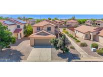 Two-story home with neutral stucco, tile roof, desert landscaping, and a two car garage at 885 E Lakeview Dr, San Tan Valley, AZ 85143