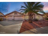 Charming single-story home with a well-manicured front yard and a three-car garage at 11065 W Runion Dr, Peoria, AZ 85373