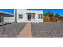 Charming white home featuring a black door, black trimmed windows, and desert landscaping at 1118 N 18Th St, Phoenix, AZ 85006