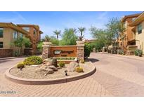 A decorative entrance to the community with lush landscaping and welcoming signage at 14450 N Thompson Peak Pkwy # 132, Scottsdale, AZ 85260