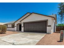 Charming single-story home with a two-car garage and low-maintenance desert landscaping at 1727 W 12Th Ave, Apache Junction, AZ 85120