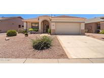 Inviting single-Gathering home featuring desert landscaping, arched entryway, and two-car garage at 17805 W Arizona Dr, Surprise, AZ 85374