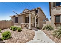Charming home featuring a covered front porch, desert landscaping, and a well-maintained walkway leading to the entrance at 17862 N 114Th Ln, Surprise, AZ 85378
