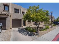 Charming townhome exterior with private garage and well-maintained desert landscaping and a tree at 1886 E Don Carlos Ave # 136, Tempe, AZ 85281