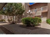 An apartment building exterior showing landscape, staircases, and walkways at 205 N 74Th St # 110, Mesa, AZ 85207