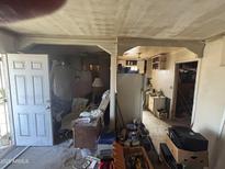 View of the living room connecting to the kitchen with open doorway at 2415 E Wood St, Phoenix, AZ 85040