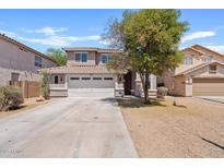 Charming home featuring a well-maintained front yard, a large driveway, and a two-car garage at 2421 S 65Th Dr, Phoenix, AZ 85043
