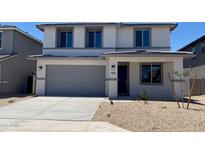 Charming two-story home with a neutral color scheme, attached garage, and simple landscaping at 31762 N Bandit Rd, San Tan Valley, AZ 85143