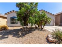 Charming single-story home featuring low maintenance desert landscaping and a two car garage at 3553 W Dancer Ln, San Tan Valley, AZ 85144